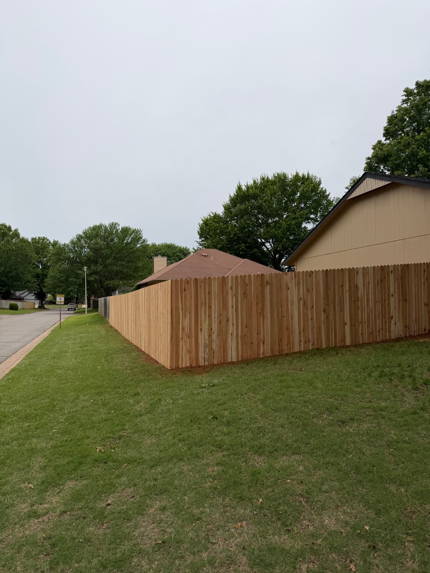 New wood privacy fence enclosing a residential corner lot