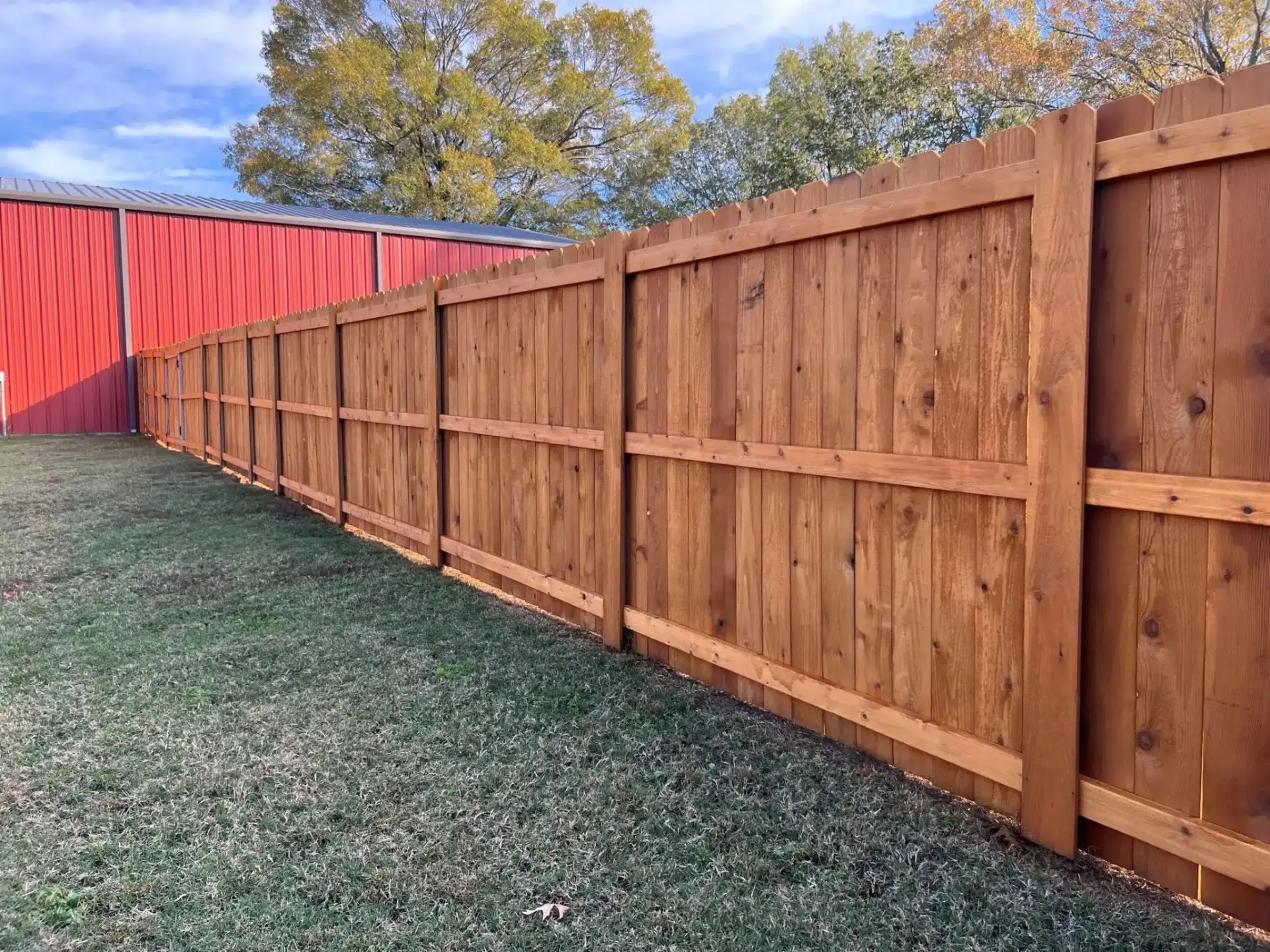Cedar wood privacy fence installed along a residential back yard