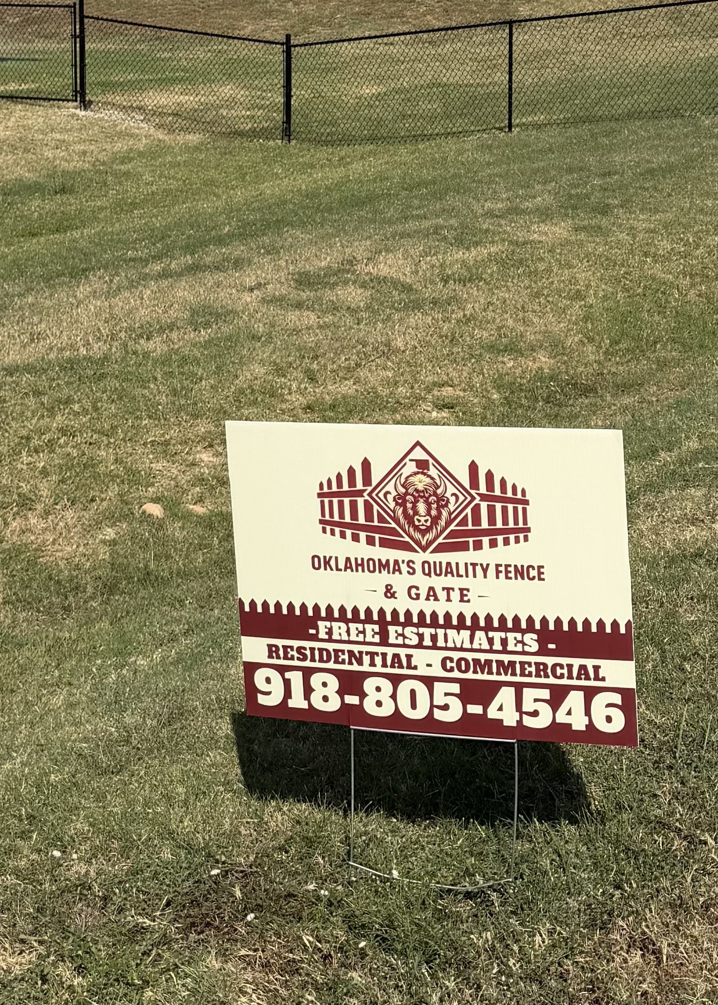 Oklahoma's Quality Fence & Gate yard sign in front of a newly installed fence